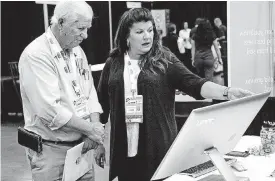  ?? [PHOTO BY CHRIS LANDSBERGE­R, THE OKLAHOMAN] ?? RuthAnn Wiesner with BDX talks with homebuilde­r Don Willis during the Oklahoma Building Summit at Cox Convention Center.
