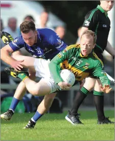  ??  ?? Cooley’s Aoghan McGuinness goes horizontal as Wayne Campbell challenges for Naomh Mairtin. Picture: Ken Finegan