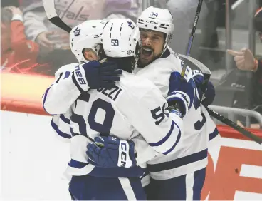  ?? NICK WASS / THE ASSOCIATED PRESS ?? Maple Leafs forward Tyler Bertuzzi celebrates his goal with Auston Matthews and Max Domi during the third period of Wednesday’s 7-3 win in Washington.
