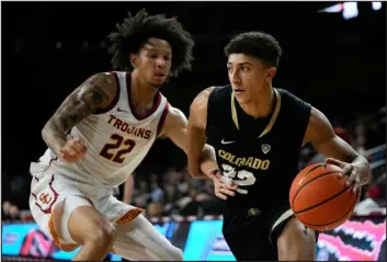  ?? ASHLEY LANDIS — THE ASSOCIATED PRESS ?? Southern California guard Tre White (22) defends against Colorado guard Nique Clifford (32) during the first half Thursday night in Los Angeles.