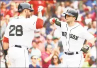  ?? Adam Glanzman / Getty Images ?? The Red Sox’s Andrew Benintendi high-fives J.D. Martinez after hitting a solo home run in the fourth inning against the Braves on Saturday.