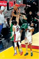  ?? REBECCA BLACKWELL/THE ASSOCIATED PRESS ?? Boston Celtics' Derrick White, left rear, scores on a putback with 0.1 seconds left Saturday in Miami at the end of Game 6 of the Eastern Conference Finals to beat the Miami Heat 104-103.