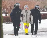  ?? ?? Police detain a man, far left, in St Petersburg, among hundreds of arrests of Russians paying tribute to Alexei Navalny, left.