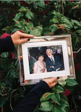  ?? GABRIELLA ANGOTTIJON­ES/ THE NEW YORK TIMES ?? Dr. Nadia Zuabi displays a photo of her parents, Vincenza and Shawki Zuabi, in Laguna Niguel, Calif., on March 8, 2021. Her father, a fellow emergency department physician, spent his last days in her hospital before dying of COVID- 19 on Jan. 8.