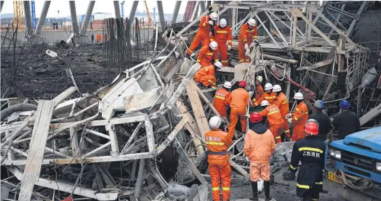  ?? Picture / AP ?? Rescue workers look for survivors after a work platform collapsed at the Fengcheng power plant in eastern China’s Jiangxi Province.