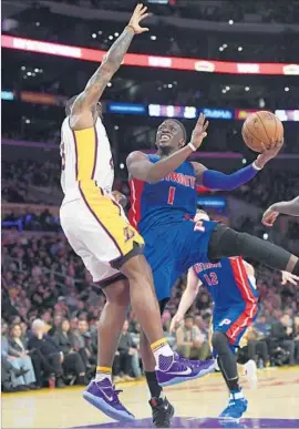 ?? Mark J. Terrill Associated Press ?? REGGIE JACKSON of the Detroit Pistons drives against Tarik Black of the Lakers in the first half. Jackson finished with 16 points in Detroit’s 102-97 victory.