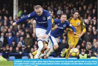  ??  ?? LIVERPOOL: Everton’s English striker Wayne Rooney shoots from the penalty spot but fails to score during the English Premier League football match between Everton and Brighton and Hove Albion at Goodison Park in Liverpool, yesterday. — AFP