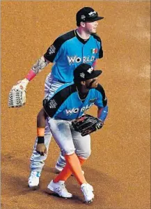  ?? Mark Brown Getty Images ?? ALEX VERDUGO, top, of the Dodgers is shown with fellow World team player Ronald Acuna during Sunday’s Futures Game.