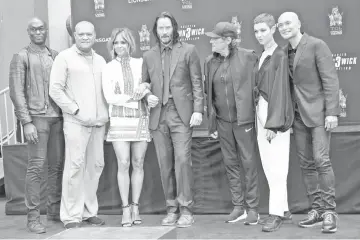  ?? photo — AFP ?? (Left to right) Actors Lance Reddick, Fishburne, Halle Berry, Reeves, Director Chad Stahelski, actors Ian McShane, Asia Kate Dillon and Mark Dacascos attend a handprint ceremony honouring Reeves at the TCL Chinese Theatre IMAX forecourt on Tuesday in Hollywood.