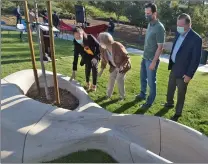  ?? Dan Watson/ The Signal ?? Artist/Architect Karen Kitayama, left, discusses the texture of “California Scape” with members of the Santa Clarita City Council on Thursday at Fair Oaks Park. On hand at the Canyon Country park for the unveiling of the limestone sculpture were, left from center, Marsha McLean, Mayor Cameron Smyth and Bob Kellar.