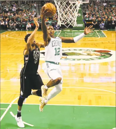  ?? Maddie Meyer / Getty Images ?? Terry Rozier, right, drives to the basket against Giannis Antetokoun­mpo during Game Two in Round One of the NBA Playoffs at TD Garden on Tuesday.