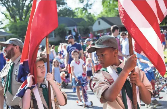  ??  ?? Brady St. Gelais, 12, left, and Ramsey Hall, 12, from Boy Scout Troop 40 prepare for the start of the 70th annual High Point Terrace Independen­ce Day parade on Thursday. BRAD VEST/THE COMMERCIAL APPEAL