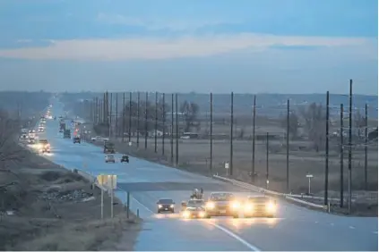  ??  ?? Large trucks and cars travel along Weld County Road 49 between I-76 and Kersey on Thursday. It will serve as a major alternate route to heavily trafficked U.S. 85, especially for the numerous oil and gas trucks that traverse the region.