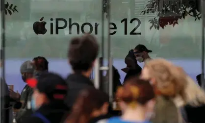  ?? Photograph: Brendan McDermid/Reuters ?? Customers wait in line outside an Apple Store to pick up the new 5G iPhone 12 in Brooklyn, New York on 23 October 2020.