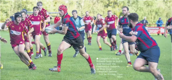  ?? Pics: Ian Horsman - Triple Effect ?? Llangefni’s Eifion Roberts looks to find a way through the Caernarfon defence, as does Huw Campbell (below)