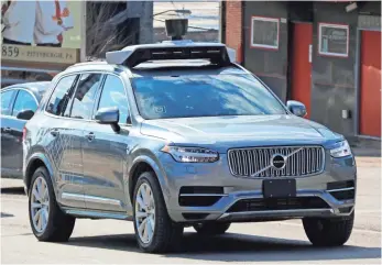  ?? GENE J. PUSKAR, AP ?? An Uber driver using an autonomous Volvo navigates the streets of Pittsburgh in March.
