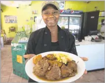  ?? Photograph­s by Francine Orr Los Angeles Times ?? ACKEE BAMBOO owner Marlene Sinclair-Beckford offers jerk chicken with steamed vegetables, festival bread and plantains.