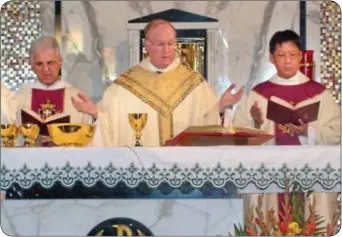  ?? Photo by Petra Chesner Schlatter ?? Father James Chia, left, was ordained to the priesthood on Saturday, Nov. 24 at St. Ignatius Church in Yardley by the Most Reverend Michael J. Fitzgerald, auxiliary bishop of Philadelph­ia.