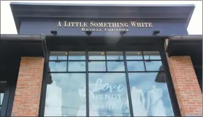  ?? Diane Farrell / Contribute­d photos ?? A Little Something White bridal couture shop in Darien has begun a social media campaign with signs in the windows such as one reading ‘Love is not cancelled.’