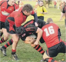  ??  ?? Wisbech pair Michael Watts( 16) and Pete Lankfer get to grips with a South Woodham Ferrers opponent.