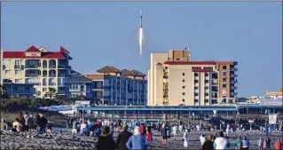  ?? MALCOLM DENEMARK/FLORIDA TODAY ?? People on Cocoa Beach watch as a SpaceX Falcon 9 rocket on a national security mission for the Space Force launches Feb. 14 at Cape Canaveral Space Force Station, Florida. The rocket carried two prototype Pentagon satellites that will be tested over the next two years.