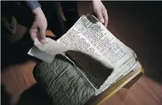  ?? BRAM JANSSEN/THE ASSOCIATED PRESS ?? This is one of centuries-old, handwritte­n biblical manuscript­s, taken away from Iraq’s Mar Matti monastery, for protection by Christians.