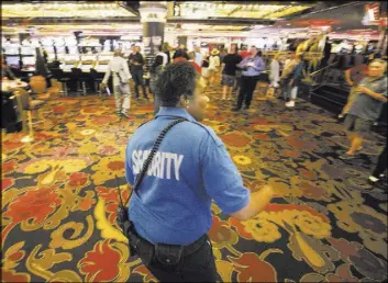  ?? Las Vegas Review-Journal ?? A security officer who declined to give her name escorts the last of the gamblers out of the Riviera on May 4, 2015, the day the casino closed its doors. The property probably had the smallest security staff among Strip hotels.