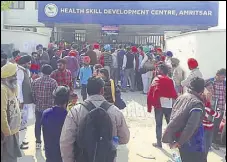  ?? HT PHOTO ?? Candidates waiting outside the skill developmen­t centre in Amritsar on Sunday.