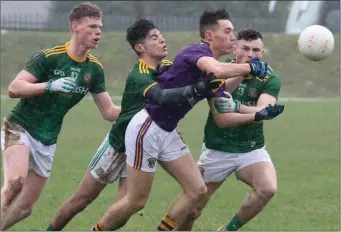  ??  ?? Defender Ciarán Kavanagh feels the heat from Meath trio Matthew Costello, Aaron Lynch and Jordan Morris.