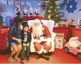  ??  ?? “Have you been naughty or nice?”: Children can tell Santa their wish lists at Rustan’s every weekend until Dec. 22.