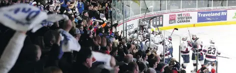  ?? KEITH HERSHMILLE­R ?? Regina Pats fans cheer Adam Brooks’s overtime goal against the Lethbridge Hurricanes.