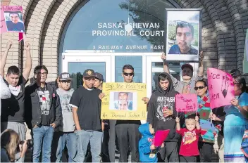  ?? LIAM RICHARDS/THE CANADIAN PRESS ?? Family, friends and supporters for Colten Boushie hold signs during a rally outside the Saskatchew­an provincial court in North Battleford in August.