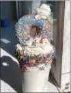  ??  ?? “Freak shakes,” like this donuttoppe­d milkshake, are a popular new trend in the ice cream industry.