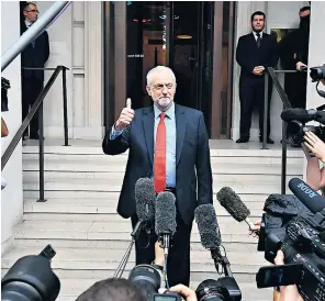  ??  ?? Jeremy Corbyn finally appeared after a meeting to give a thumbs-up and declare the Labour manifesto to be ‘very popular’