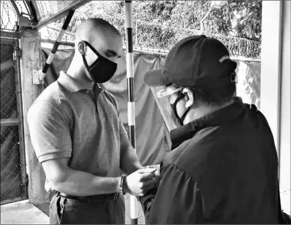  ?? Bureau of Immigratio­n via AP ?? In this photo provided by the Philippine­s’ Bureau of Immigratio­n, U.S. Marine Lance Cpl. Joseph Scott Pemberton has handcuffs placed before leaving Camp Aguinaldo on his way to the airport in Quezon city, Philippine­s, on Sunday.