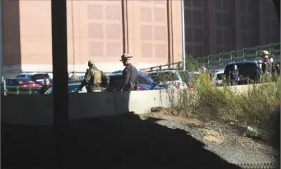  ?? Photo by Ernest A. Brown ?? Rhode Island State Police converge on the Memorial Boulevard on ramp to Route 95 near Providence Place Mall Thursday.