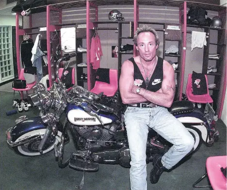  ?? RICK LOUGHRAN ?? Lions assistant coach Jeff Reinebold strikes a casual pose with his Harley Davidson motorcycle in the team dressing room.