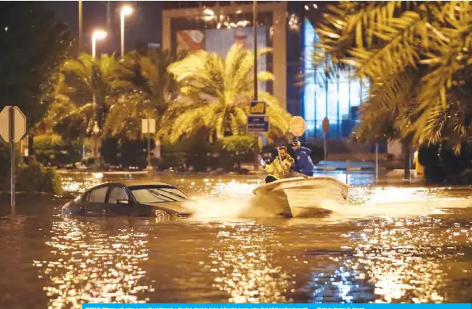  ??  ?? KUWAIT: Citizens sail using a speedboat through a flooded street in Daiya following heavy rains that hit Kuwait last month. — Photo by Yasser Al-Zayyat