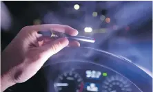  ?? THE CANADIAN PRESS ?? A driver is behind the wheel with a cannabis-oil vaporizer. Canada legalized recreation­al marijuana for adults on Oct. 17, but it’s still illegal to drive impaired.