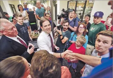  ?? Gerald Herbert Associated Press ?? SUPPORTERS GREET Marco Rubio at a campaign stop in Lakeland, Fla. He was in his home state all week, focusing on young suburbanit­es and Cuban Americans in a bid to repeat his 2010 Senate victory.