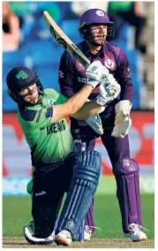  ?? AFP ?? Helping hand: It was a nip-and-tuck affair between two neighbouri­ng countries. Scotland put up a good fight but Ireland just managed to get its nose ahead at the end, Curtis Campher playing a crucial innings of 72 (unbeaten, 32b).
