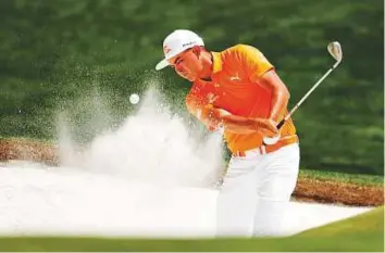  ?? AFP ?? Rickie Fowler plays a shot from a bunker on the first hole during the final round of the 2018 Wells Fargo Championsh­ip on Sunday in North Carolina. He finished tied for 21st at the Championsh­ip.