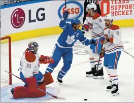  ?? FRANK GUNN — THE ASSOCIATED PRESS ?? The Toronto Maple Leafs’ John Tavares celebrates after scoring on Montreal Canadiens goaltender Carey Price during the first period of Wednesday’s season opener in Toronto.