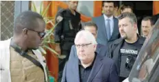  ?? — Reuters ?? UN envoy to Yemen Martin Griffiths is escorted by bodyguards as he arrives at Sanaa airport on Saturday.