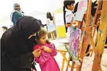  ?? Courtesy: SCRF ?? Shaikha Jawaher with children during a workshop at the Sharjah Children’s Reading Festival yesterday.