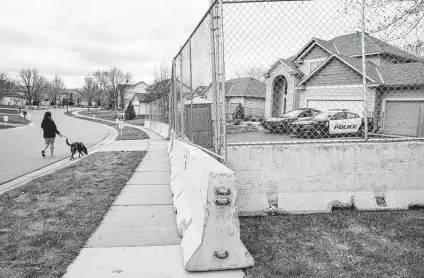  ?? John Minchillo / Associated Press ?? Fencing and concrete barriers surround the home of former Brooklyn Center police officer Kim Potter in Champlin, Minn.