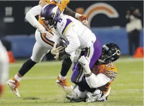  ?? NAM Y. HUH/THE ASSOCIATED PRESS ?? The Vikings’ Kirk Cousins is sacked by the Bears’ Khalil Mack last Sunday. The Minnesota pivot struggled mightily in the key divisional battle in Chicago, with his club losing 25-20.