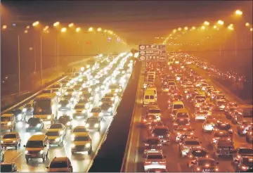  ??  ?? Vehicles drive along the 4th ring road among heavy smog in Beijing, China. — Reuters photo