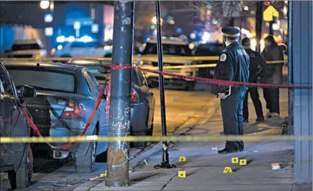  ?? TERRENCE ANTONIO JAMES/CHICAGO TRIBUNE ?? Chicago police officers process a crime scene on Jan. 16. Police quietly ended a controvers­ial data-gathering effort to predict crime in November.