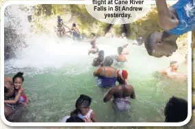  ??  ?? Persons enjoying themselves at Cane River Falls, located just outside of Nine Miles in Bull Bay, St Andrew, yesterday.